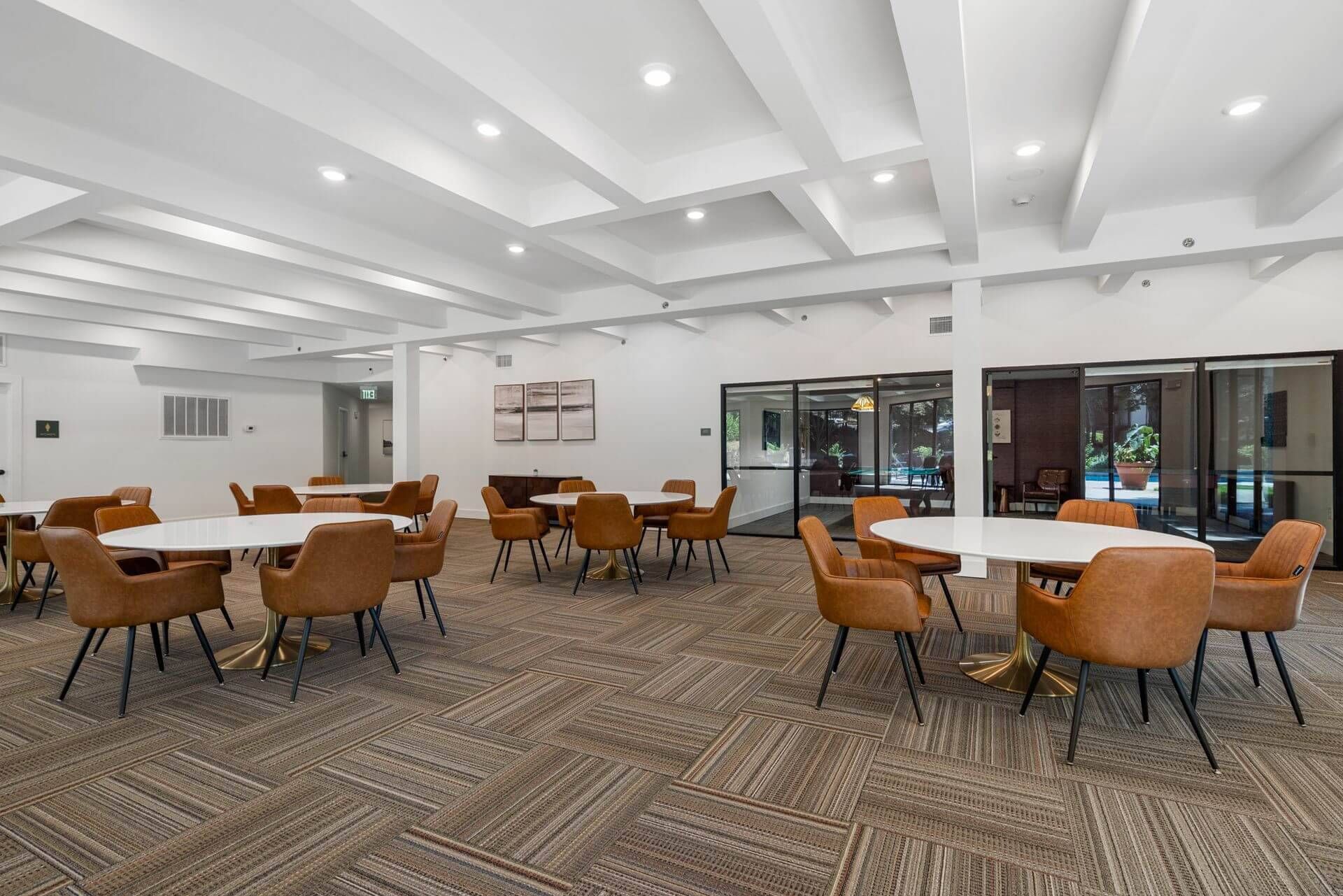 Dining room with coffered ceiling and warm lighting at Clairmont Crest senior living apartments in Decatur, GA.