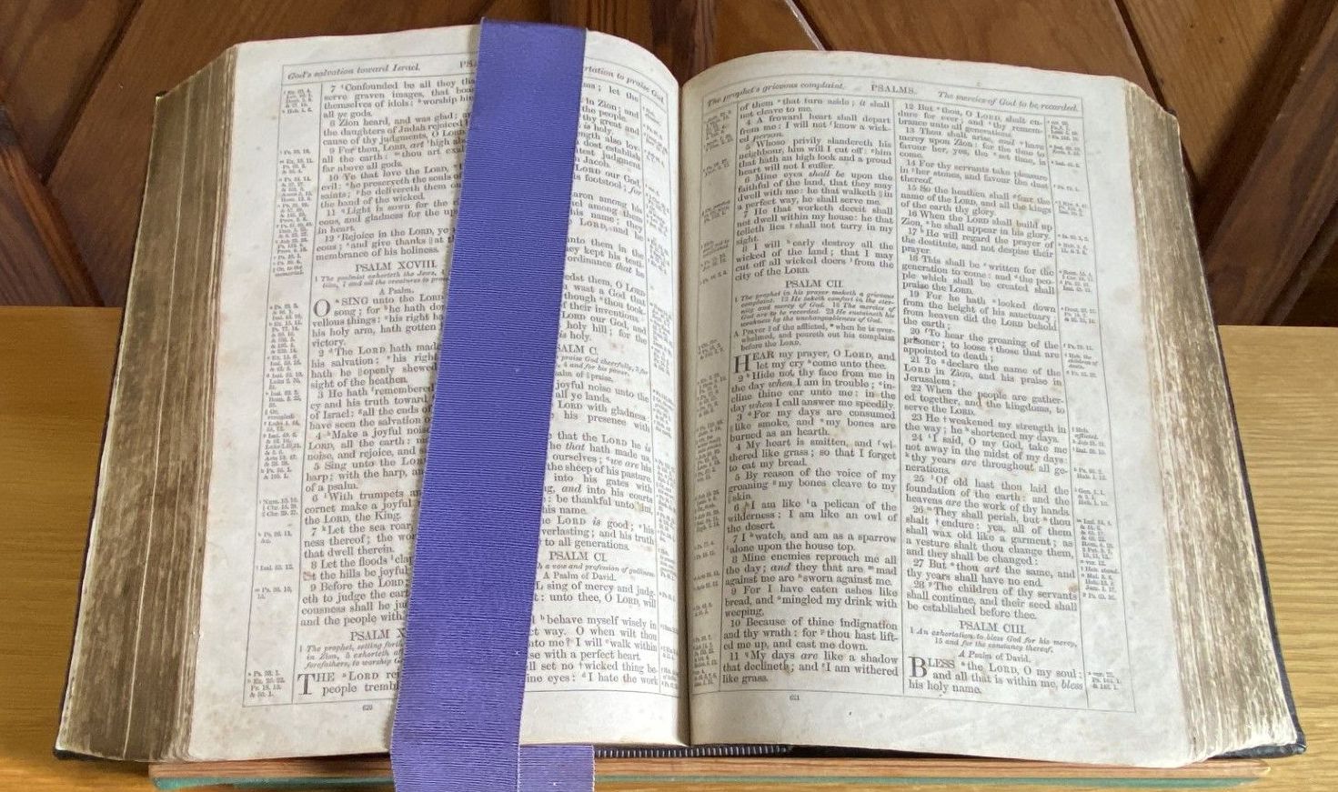 A group of people are standing in a church while a man stands at a podium.