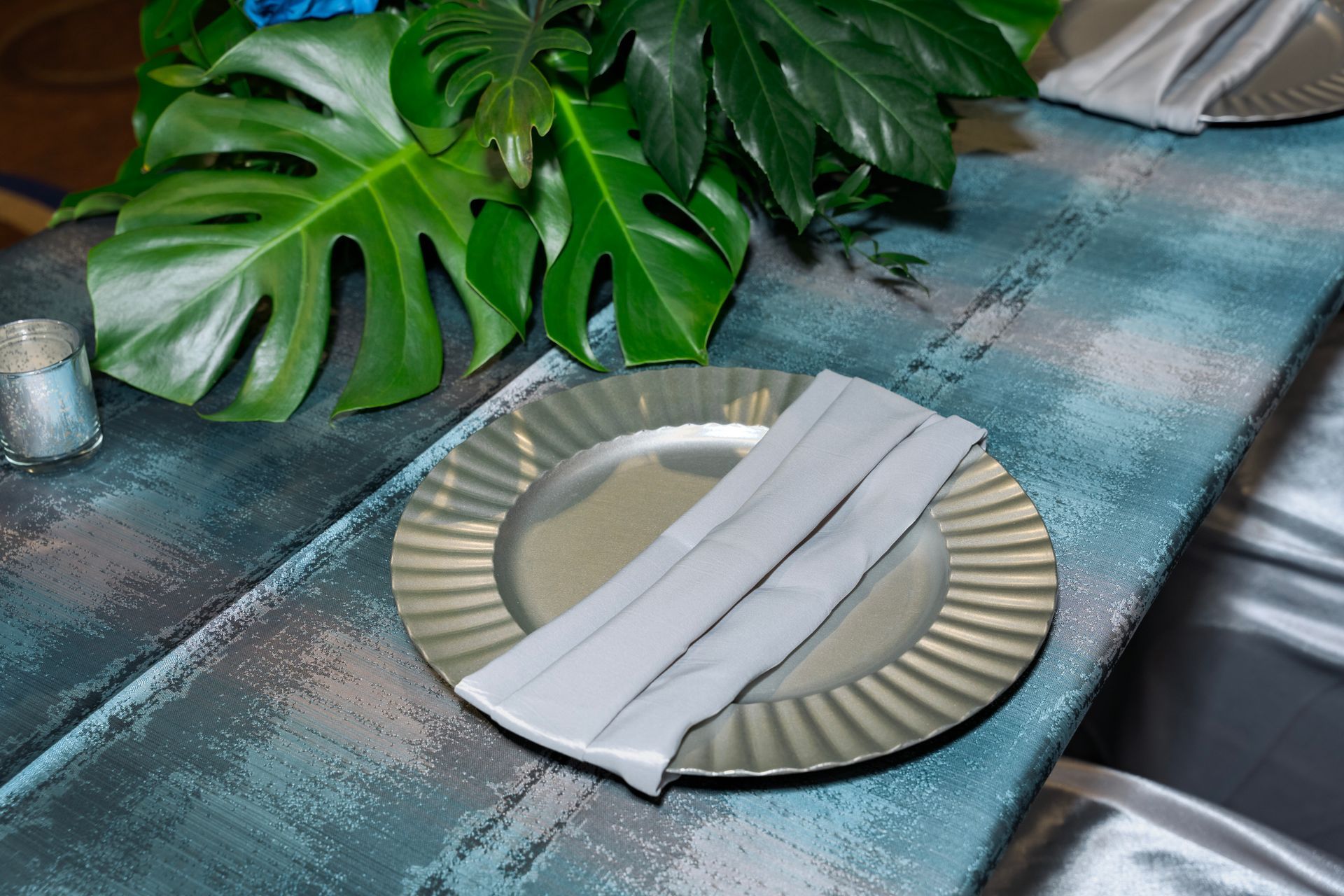 A plate with a napkin on it is on a table.