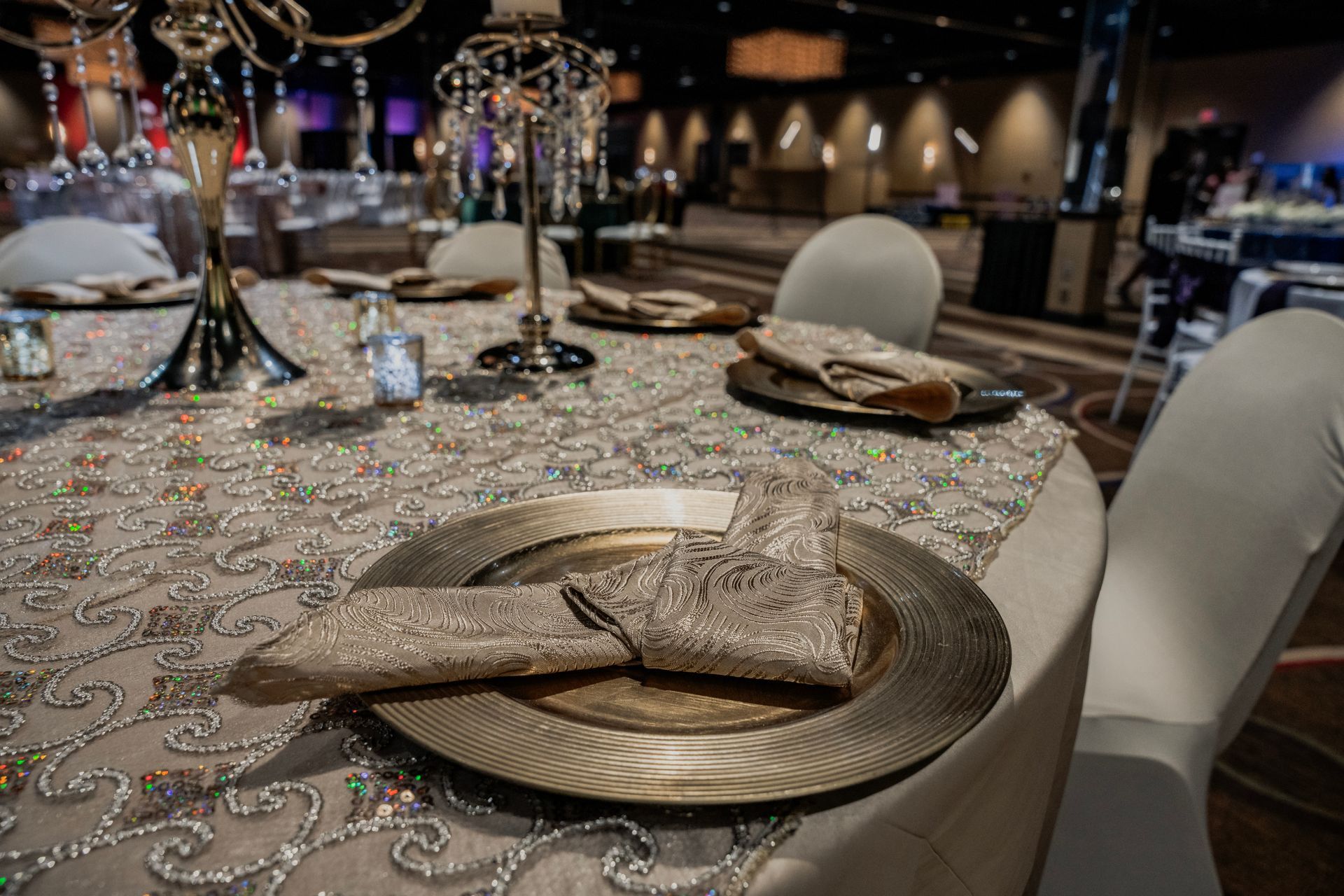 A table set for a wedding reception with plates and napkins on it.