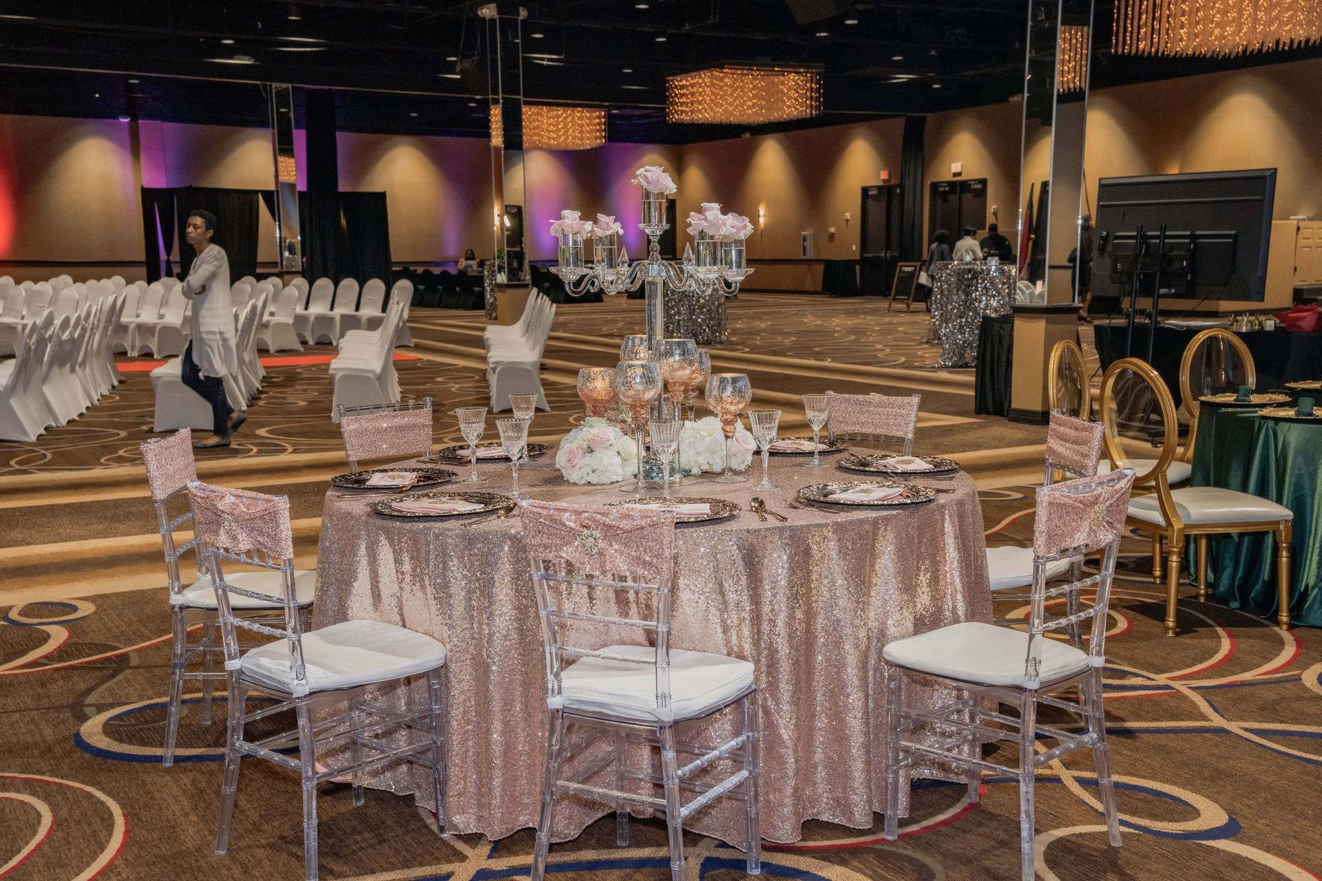 A large room with tables and chairs set up for a wedding reception.