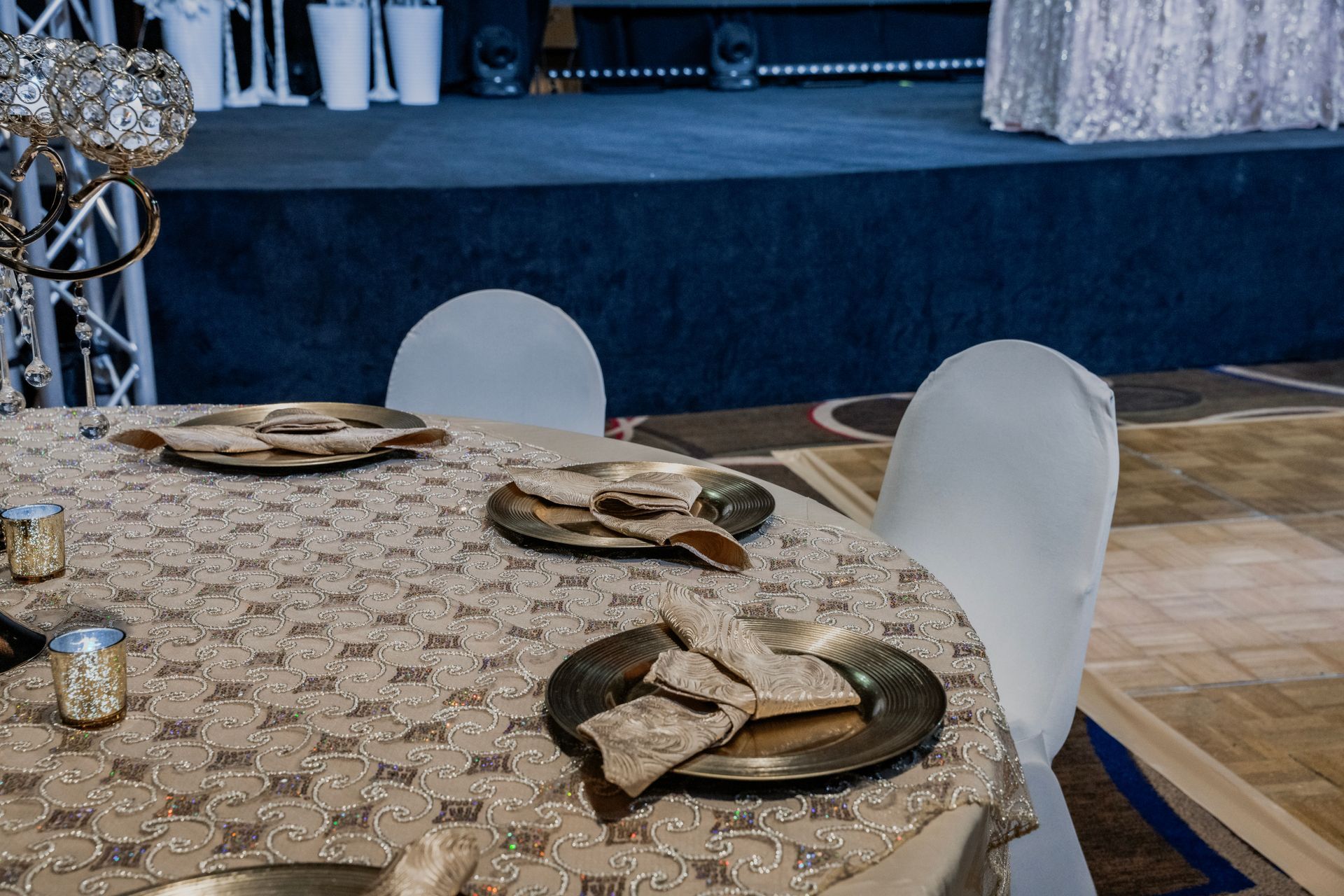 A table with plates and napkins on it in front of a stage.