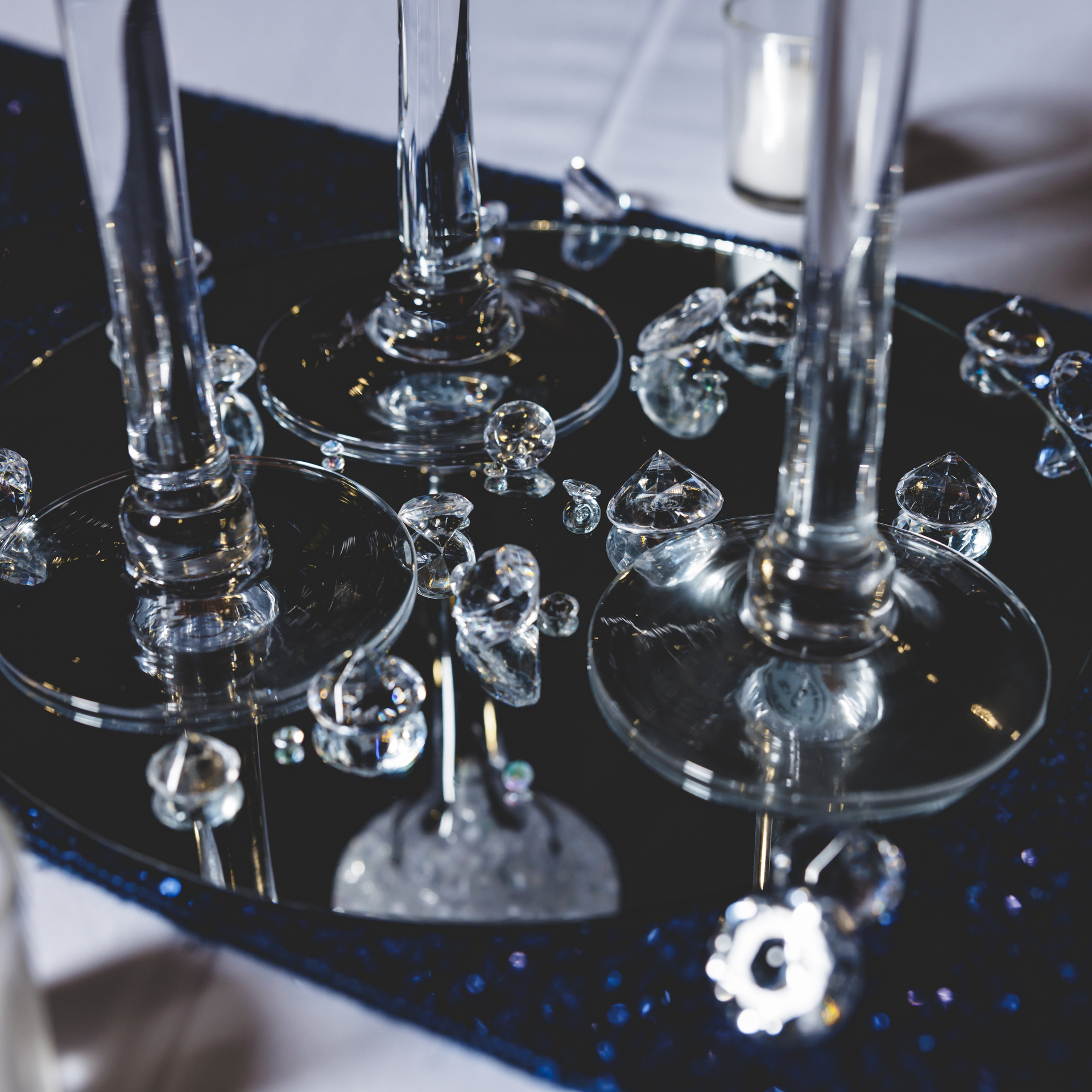 A tray with wine glasses and crystals on it