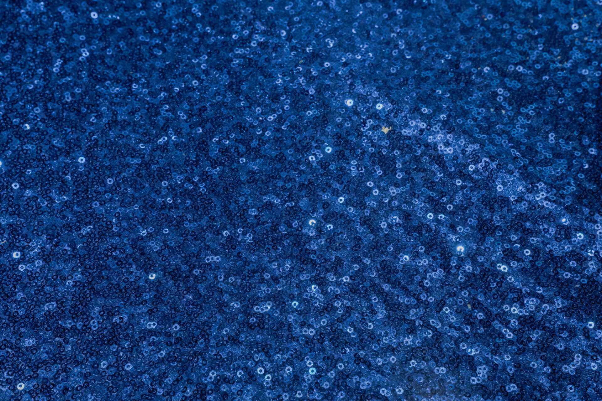 A close up of a blue sequined fabric.