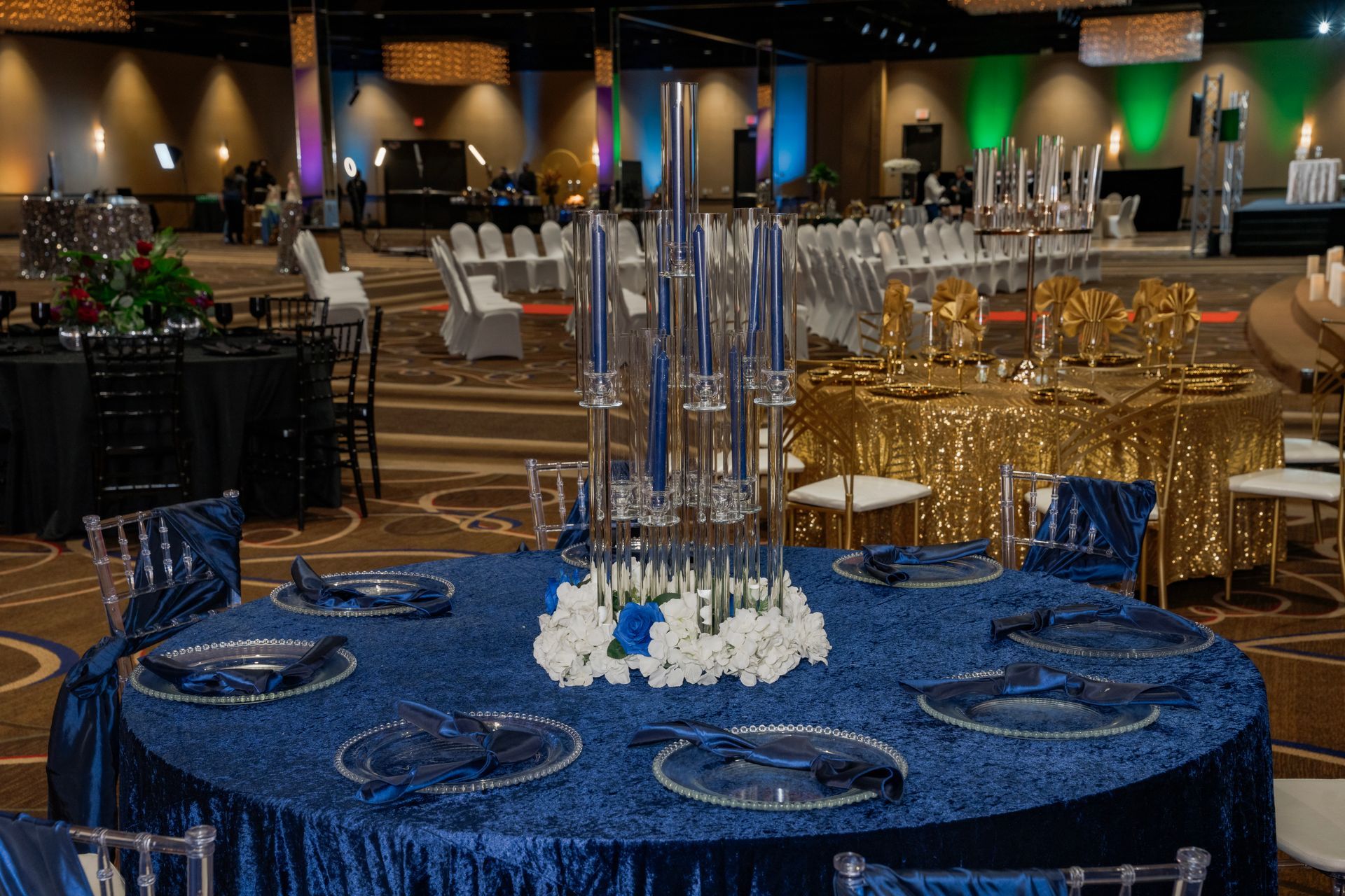 A large room with tables and chairs set up for a wedding reception.