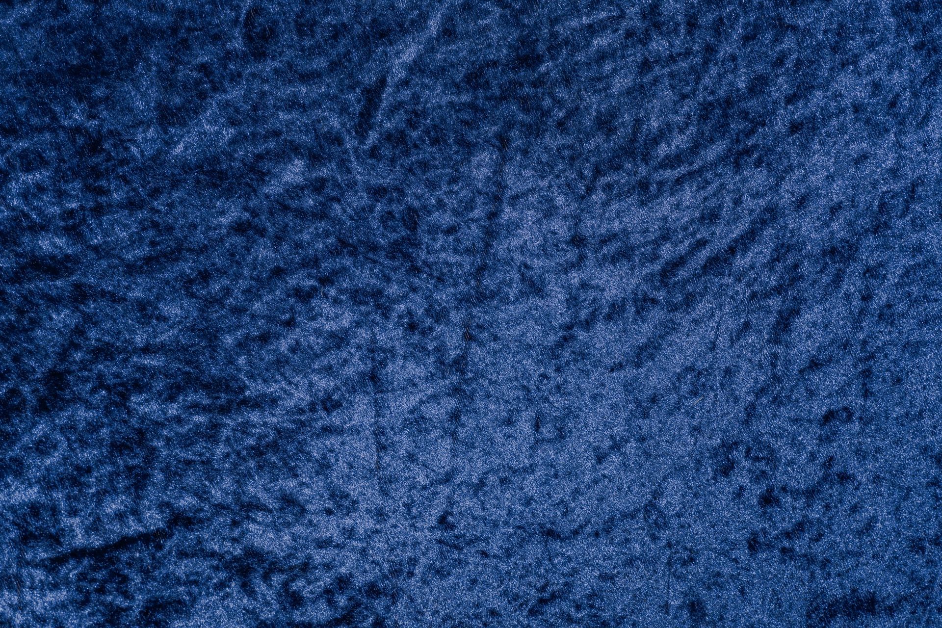 A close up of a blue velvet texture.