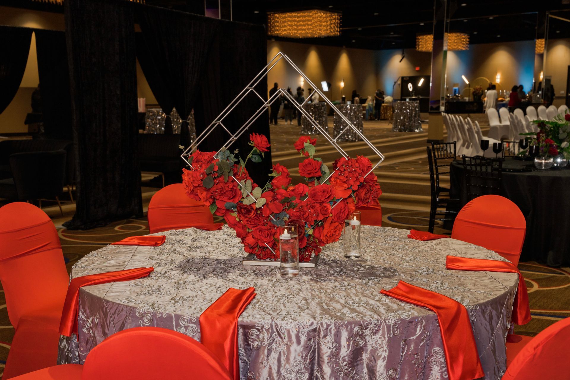 A large room with tables and chairs set up for a wedding reception.