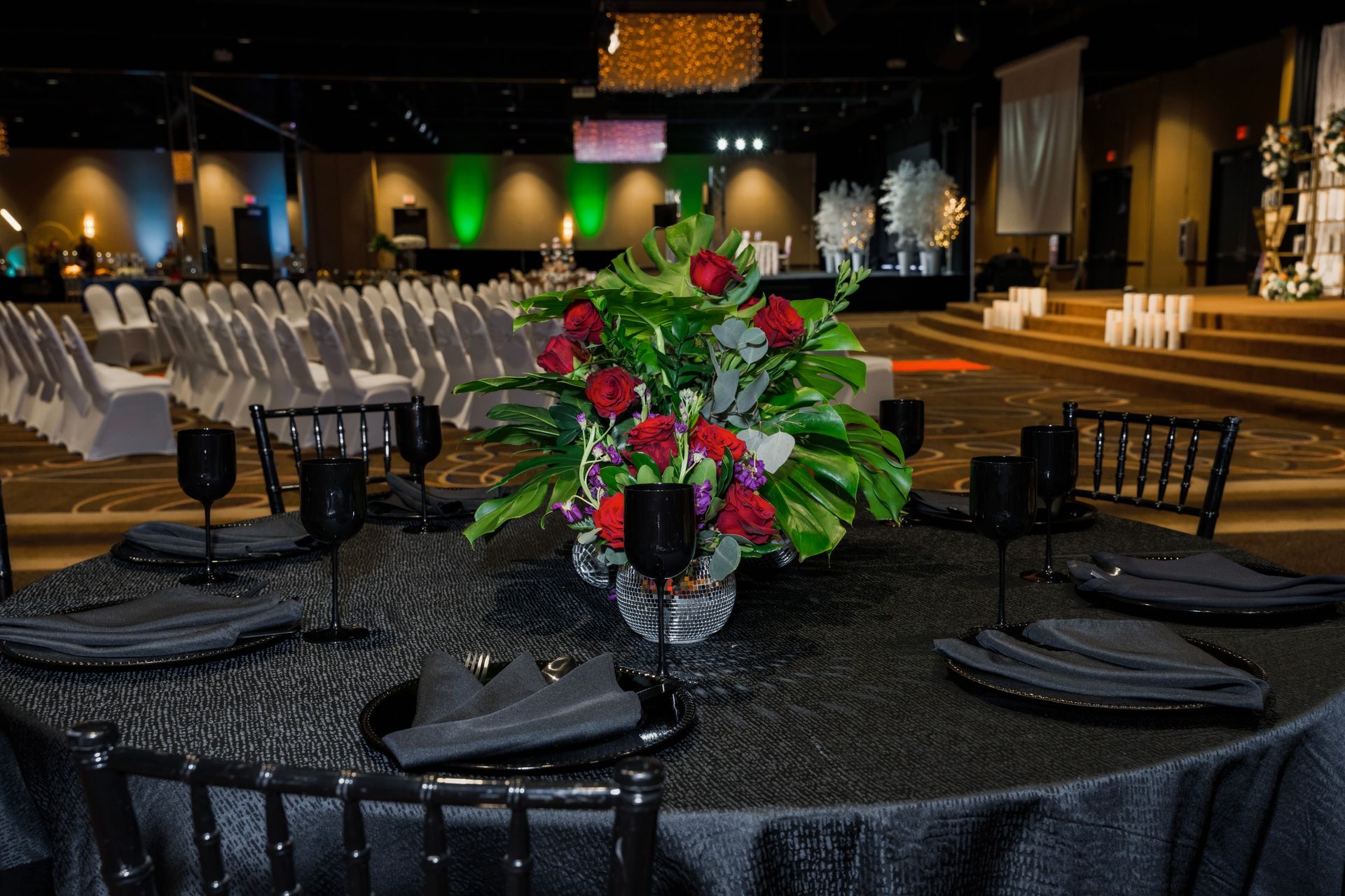 A table set for a banquet with a vase of flowers on it.