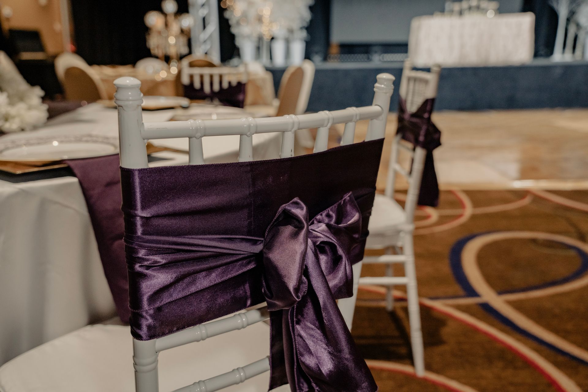 A white chair with a purple bow on the back.