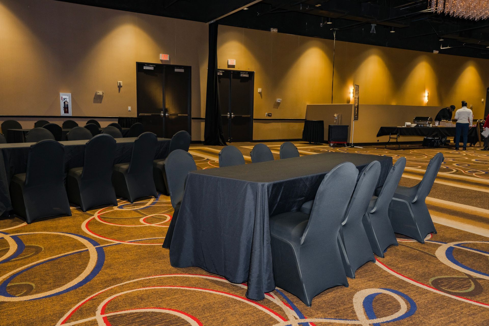 A large room with tables and chairs set up for a conference.
