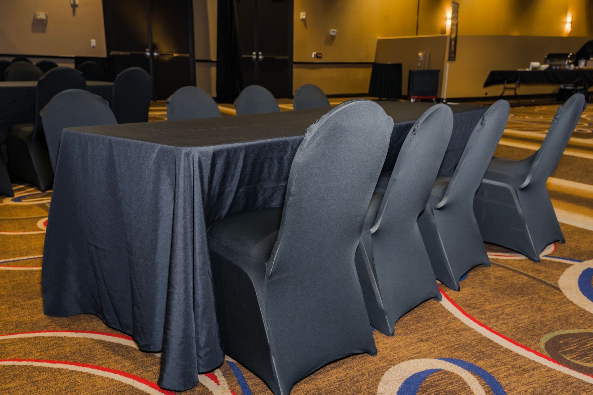 A conference room with tables and chairs set up for a meeting.