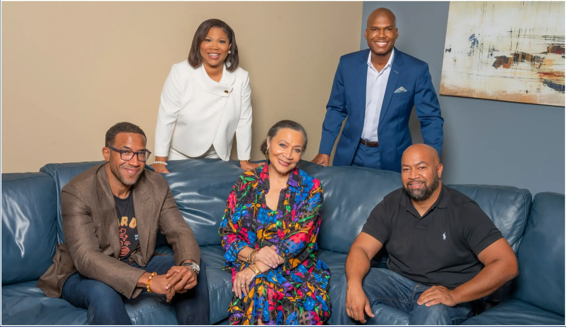 The Collective's Founding members posing for a picture while sitting on a couch.
