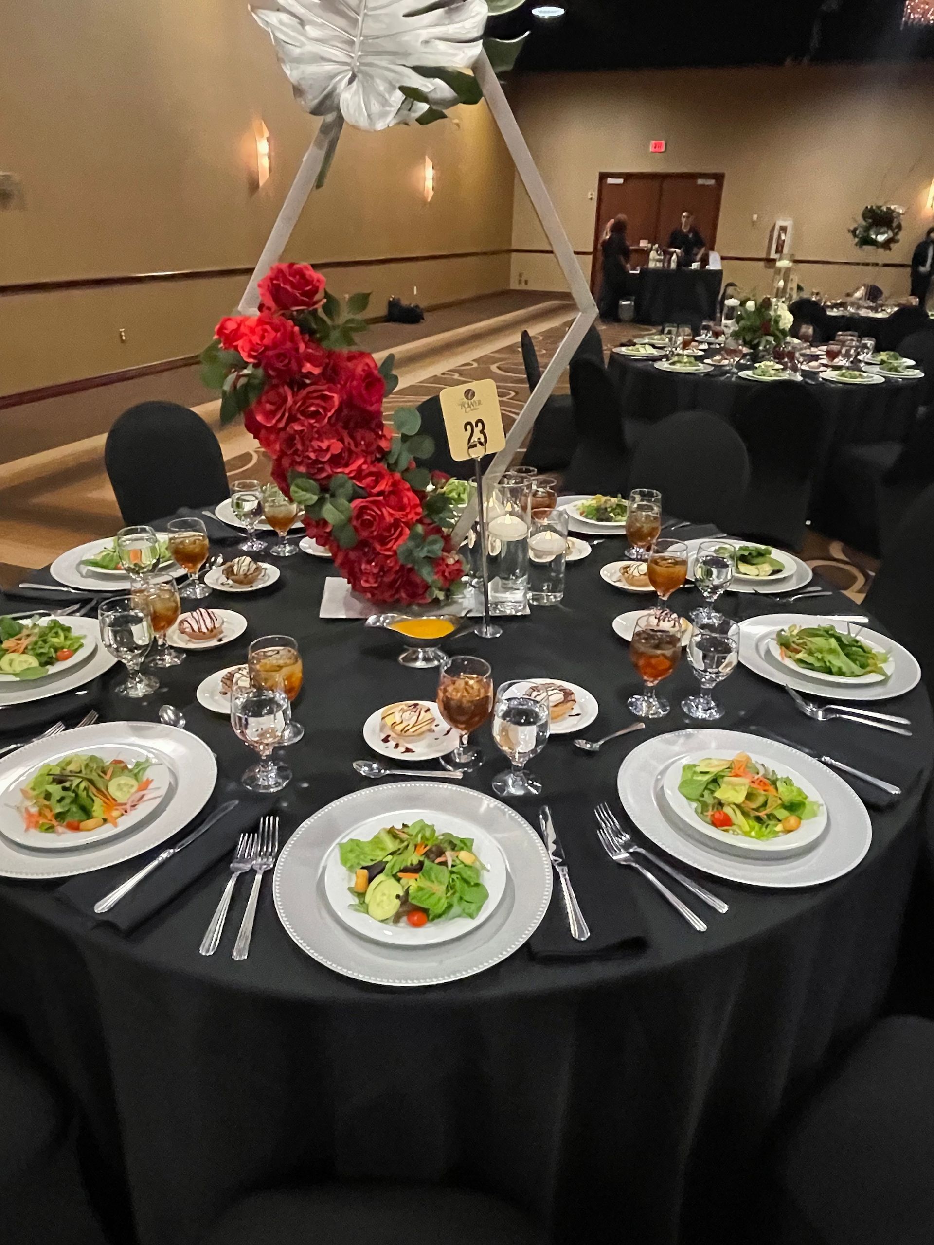 A table set for a banquet with plates of food and glasses of wine