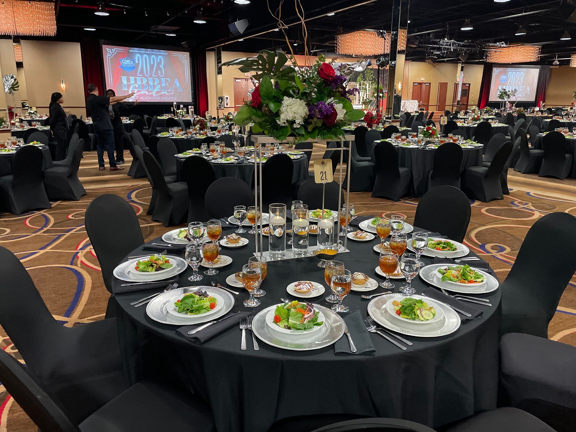 A large room with tables and chairs set up for a banquet.