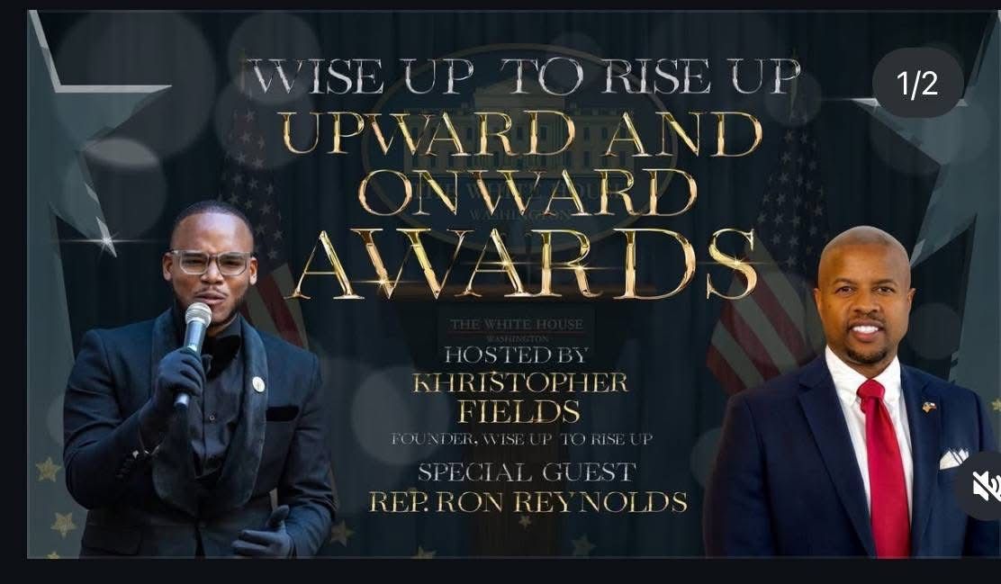 Two men are standing in front of a sign that says wise up to rise up upward and onward awards