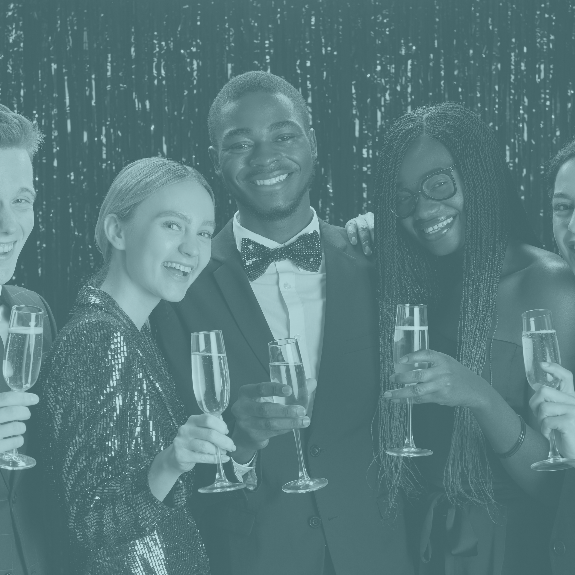 A group of people are standing next to each other holding champagne glasses.