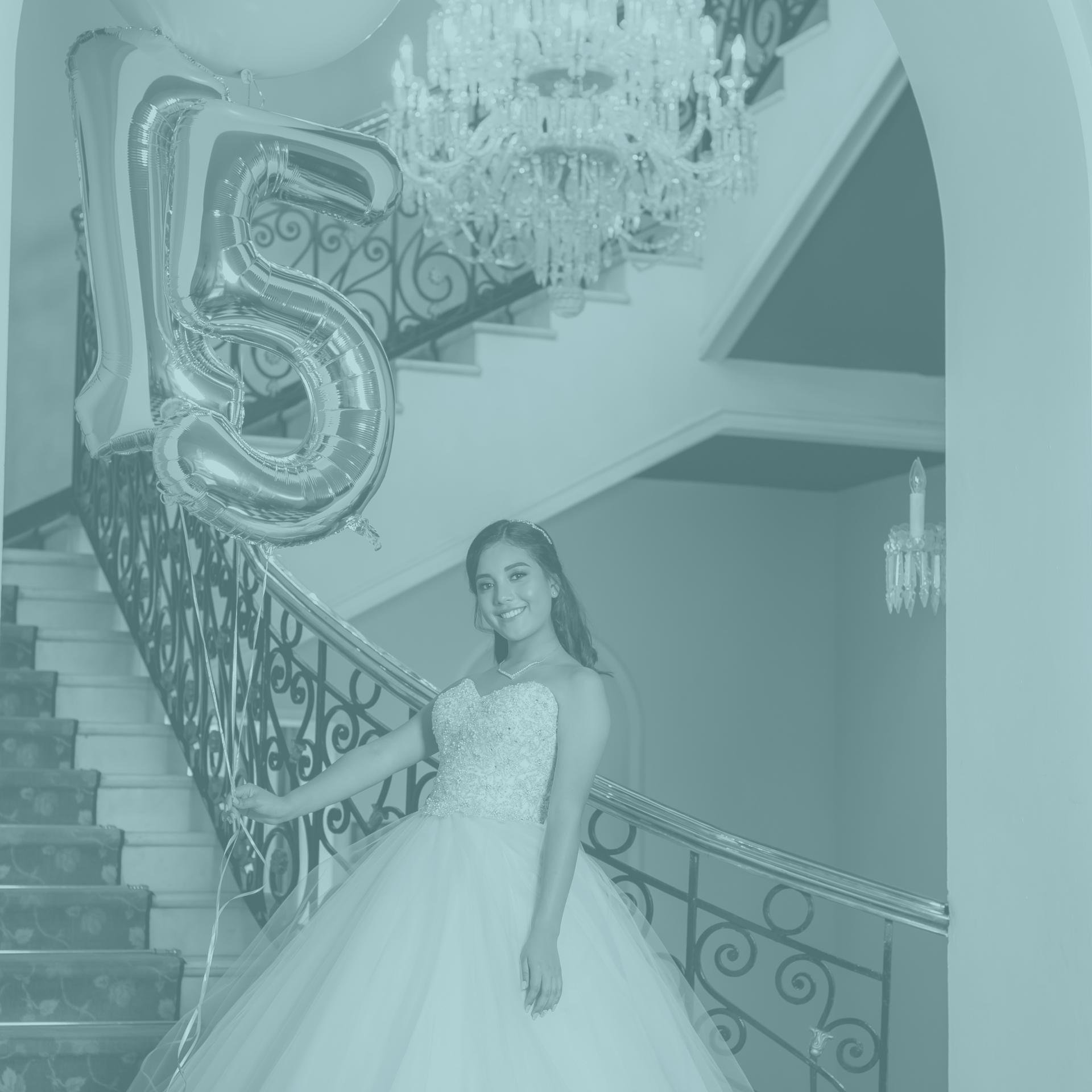 A woman in a wedding dress is standing on a set of stairs with balloons.