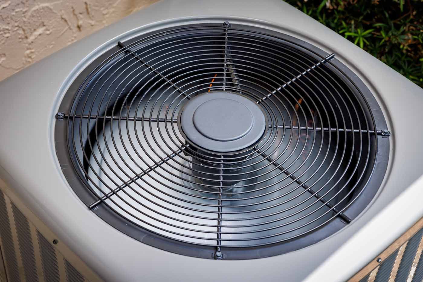 A close up of an air conditioner with a fan on top of it.