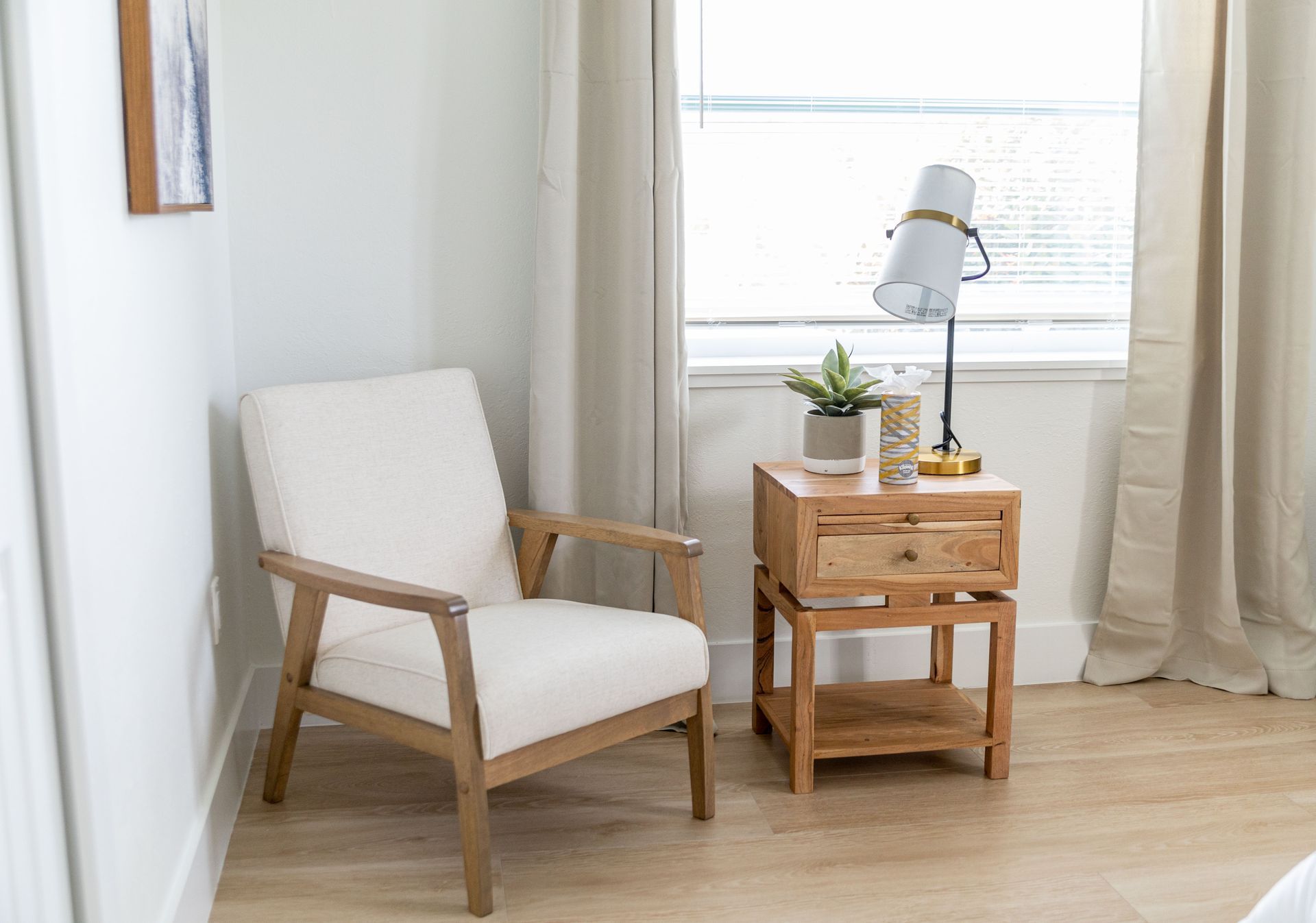 There is a chair and a nightstand in the room.