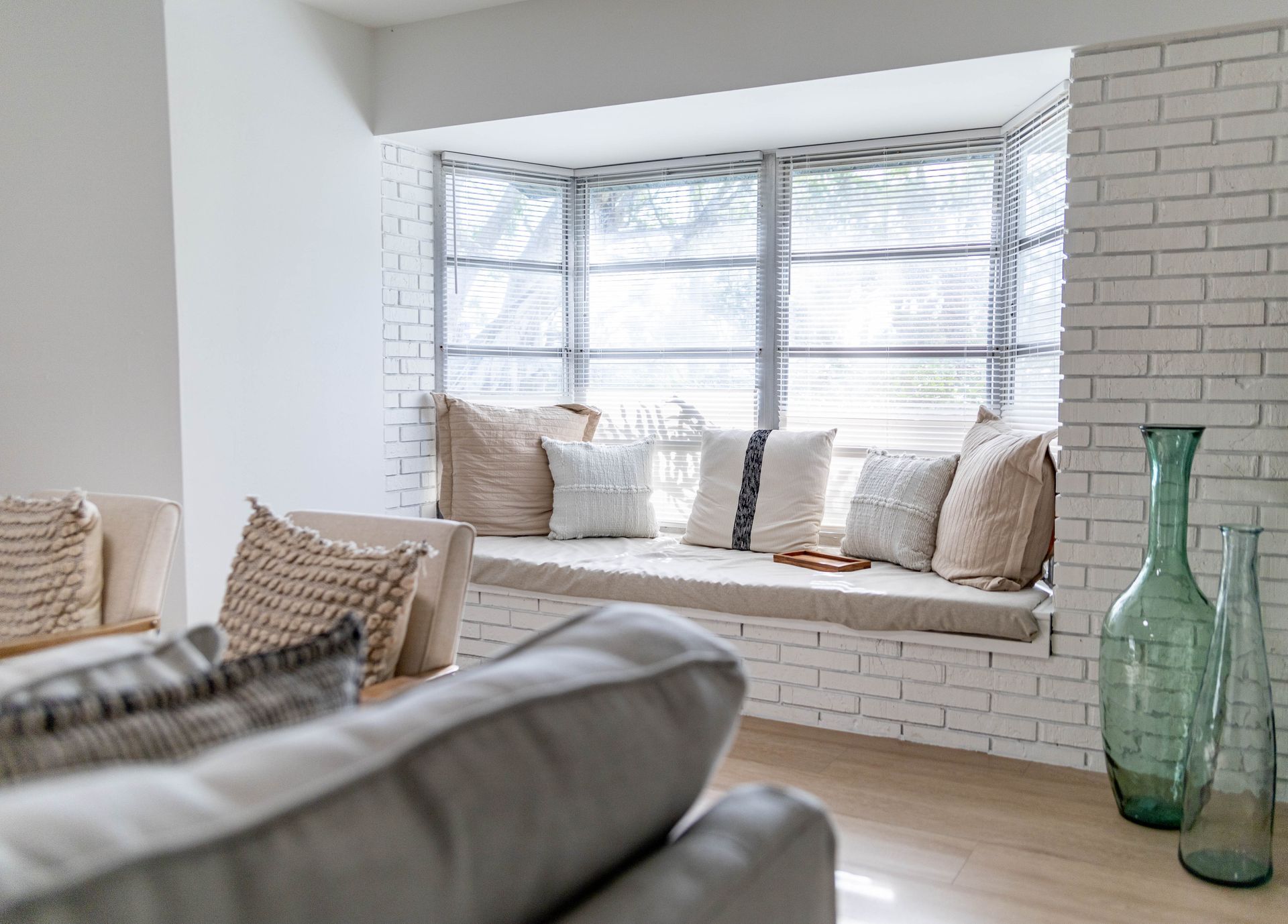 A living room with a window seat and a couch.