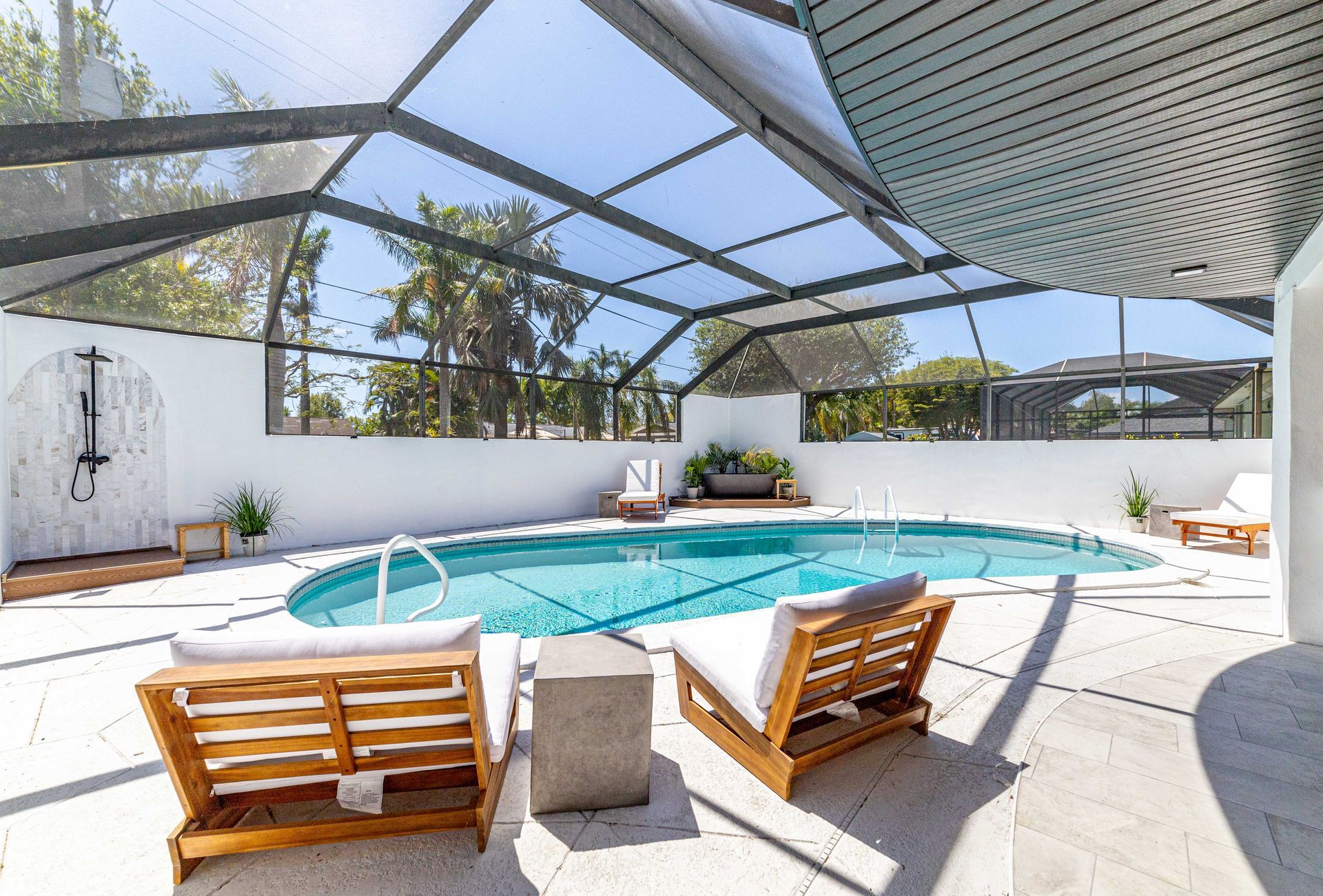 A large indoor swimming pool with a screened in area