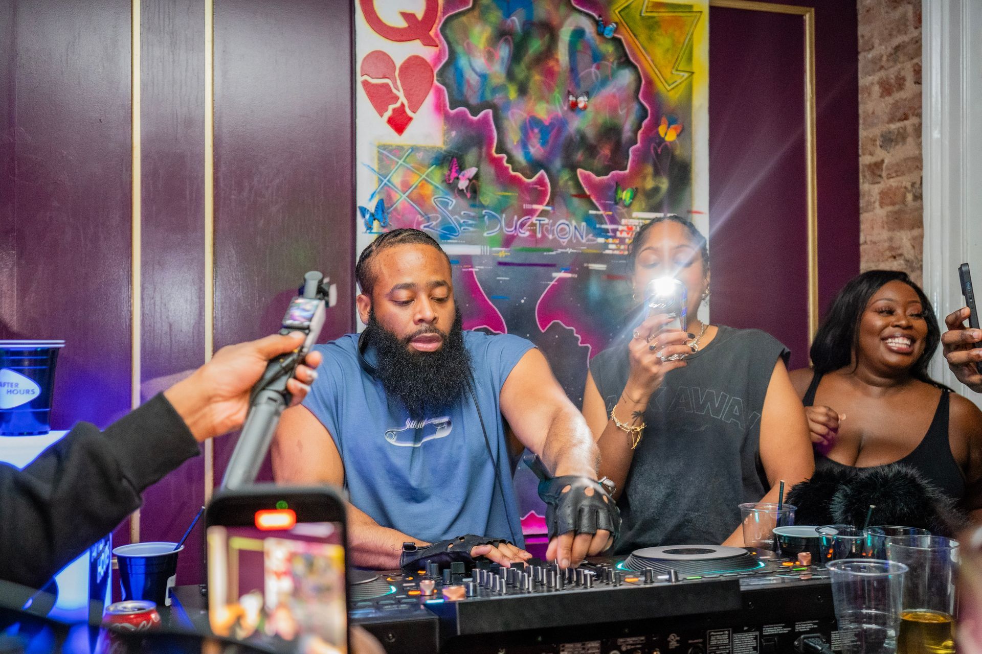 A group of people are sitting at a table playing music.