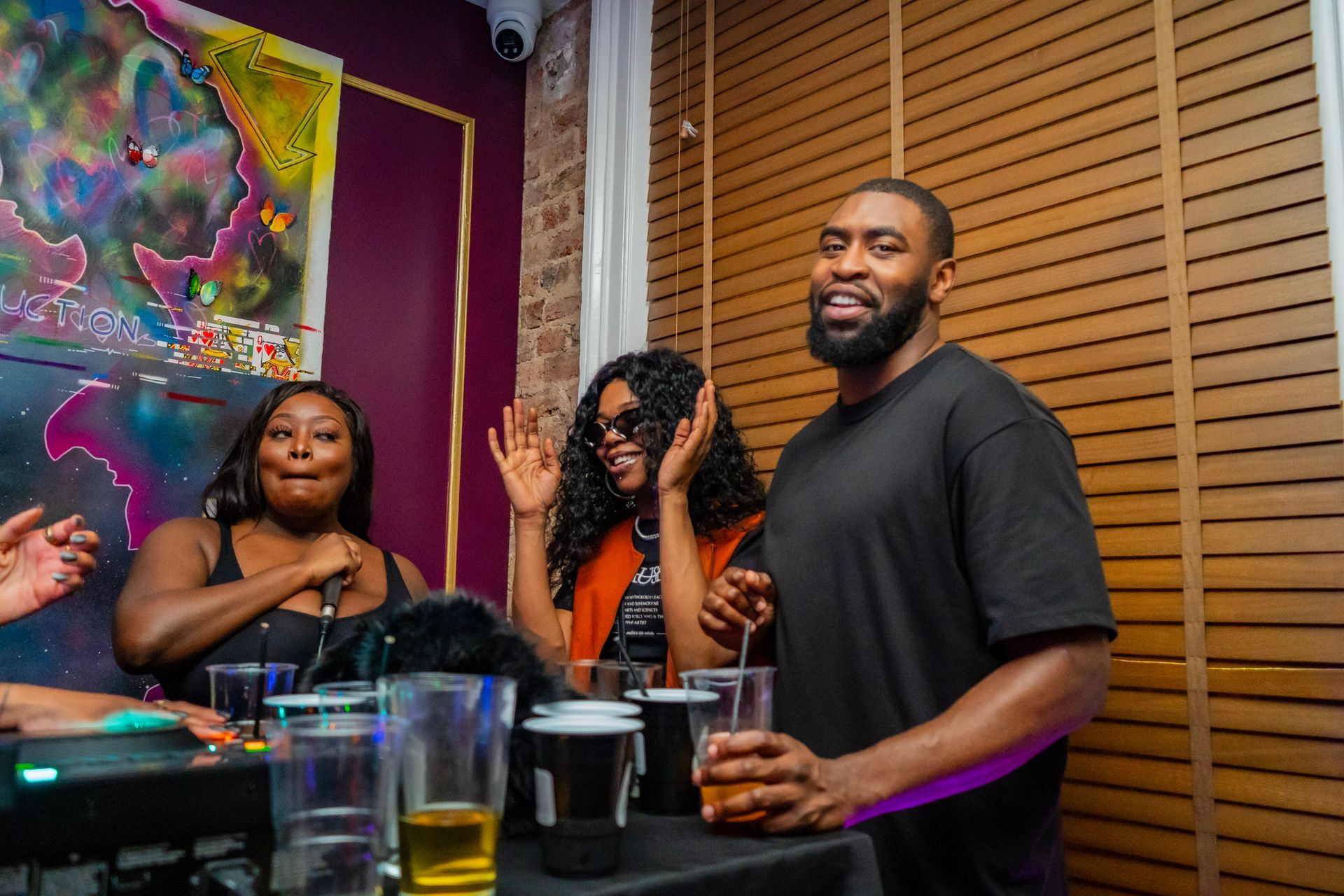 A man and two women are standing next to each other in a room.