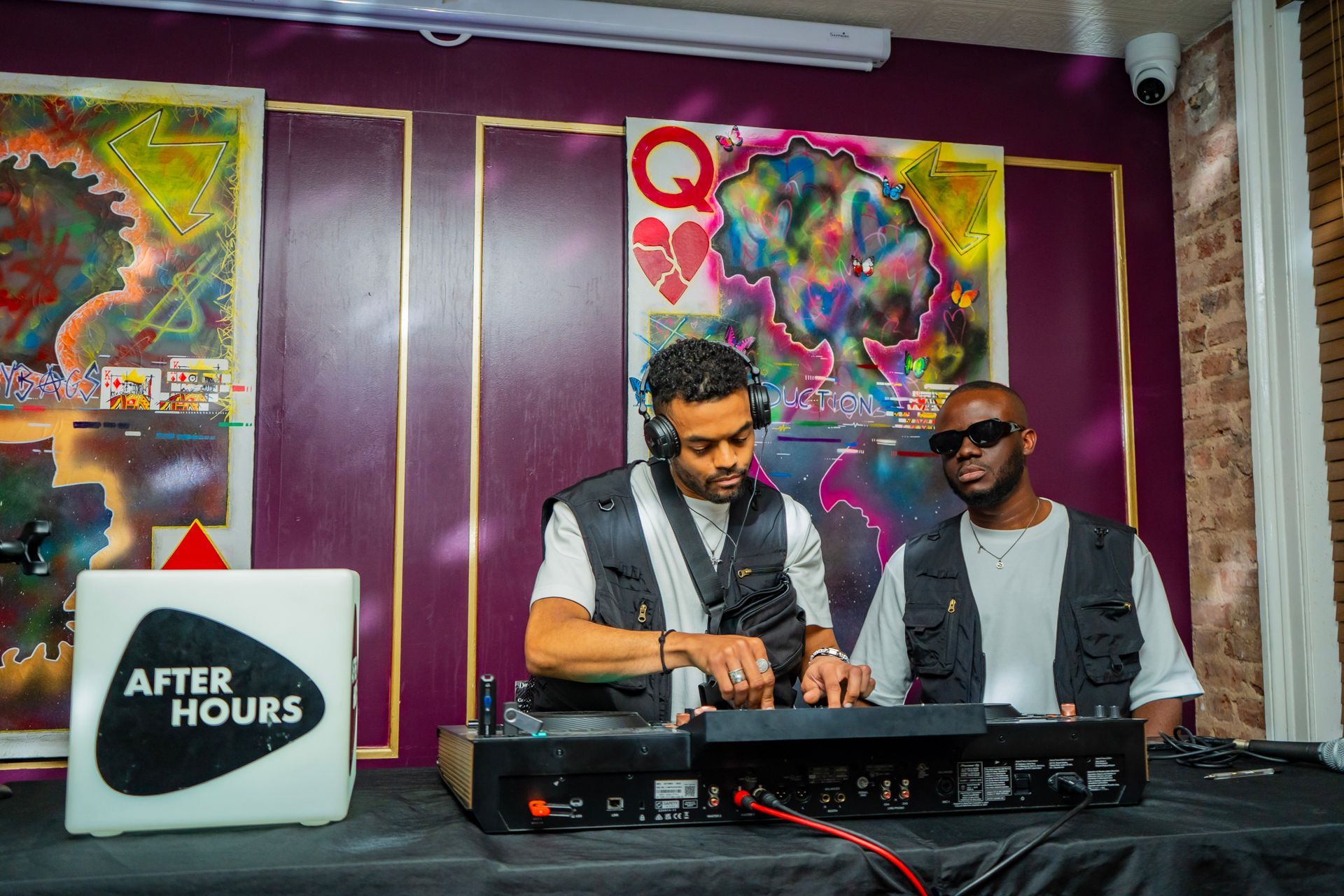 Two men are sitting at a table playing music.