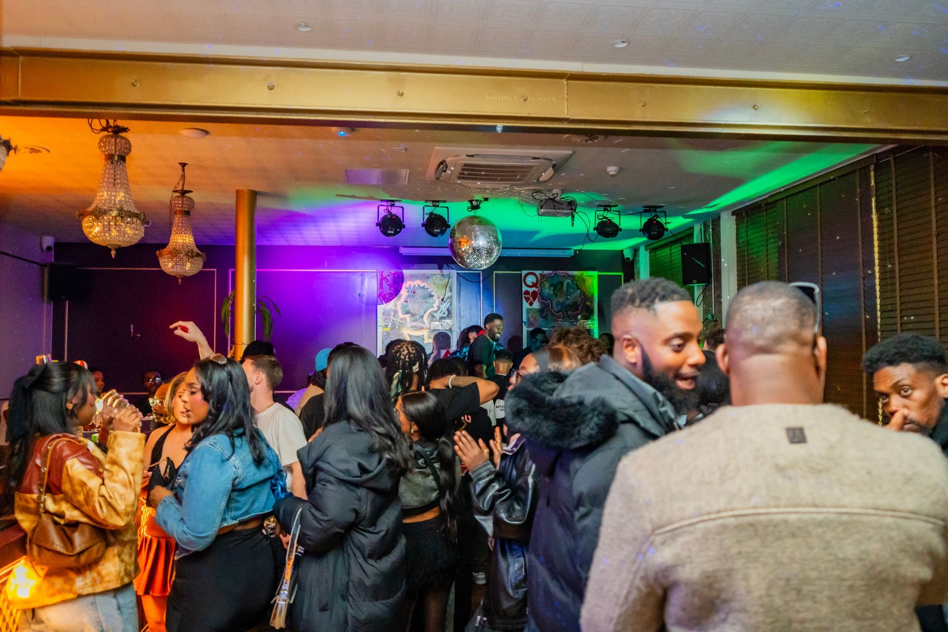 A group of people are dancing in a room at a party.