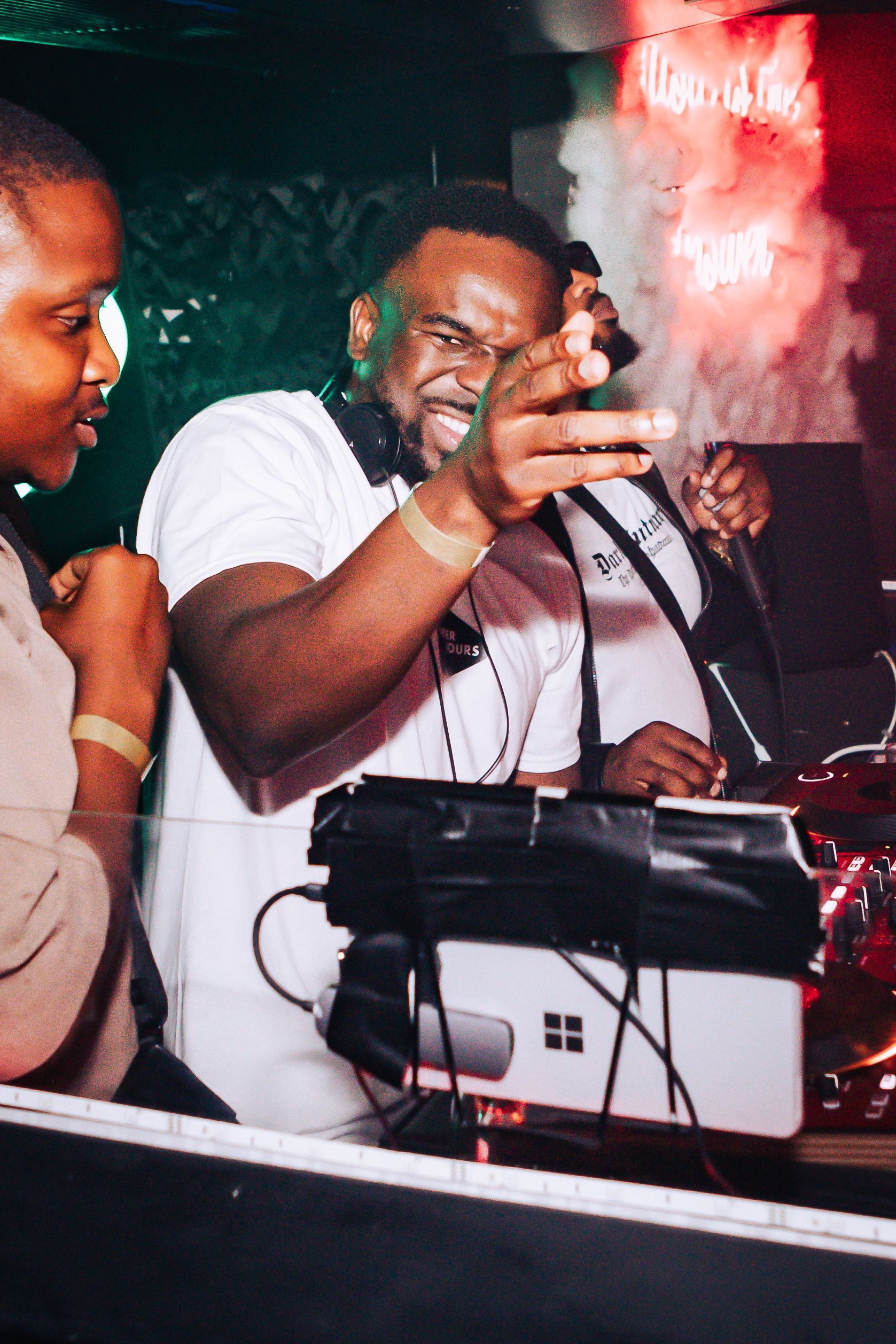 A man is taking a picture of himself while playing music in a club.
