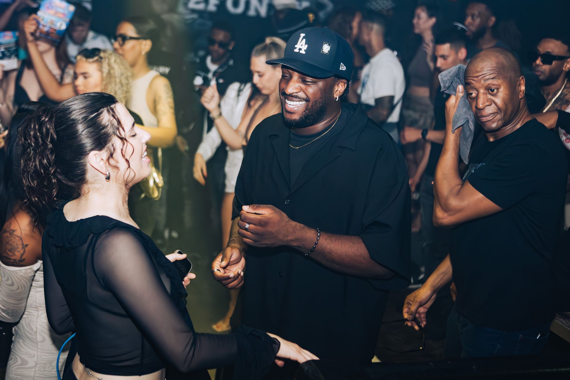 A man and a woman are dancing together in a club.