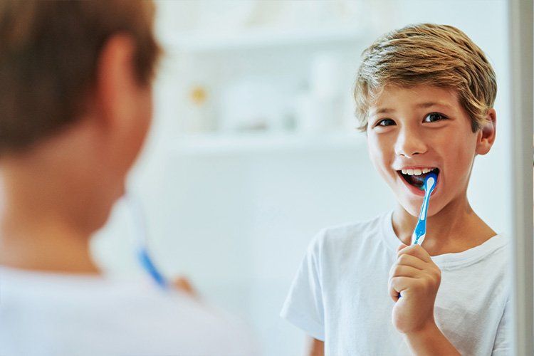 Adolescent youth brushing his teeth - Dental Studio 4 Kids Lutz Florida