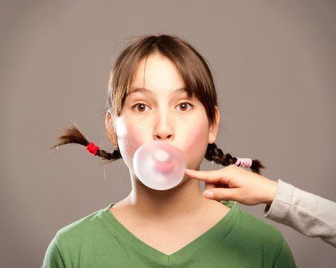 young girl chewing gum