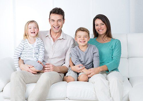 family on couch smiling