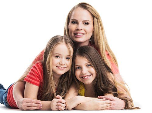 mother and 2 daughters smiling