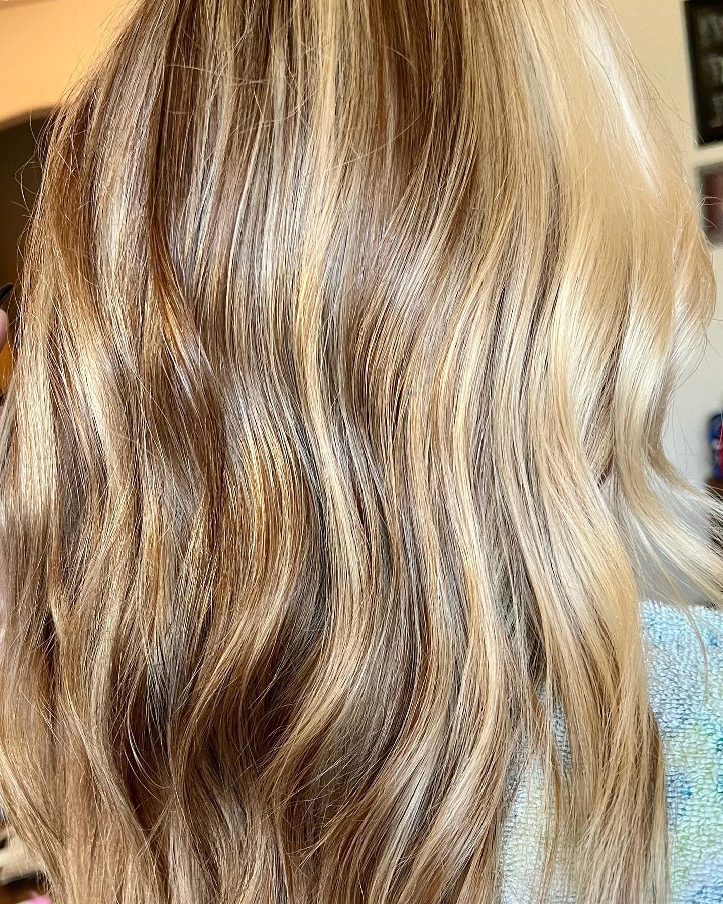 Wavy blonde and brown highlighted hair, styled and blown out.