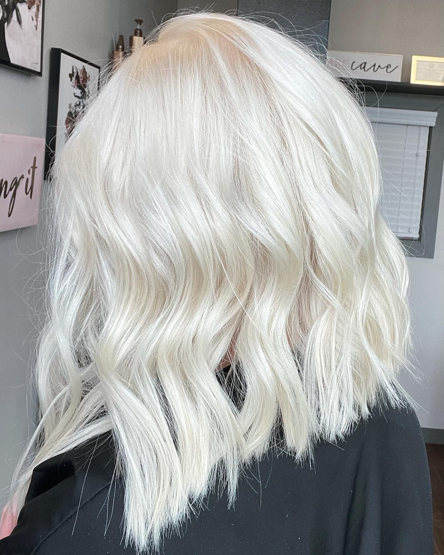 Woman with wavy, light blonde, shoulder-length hair.