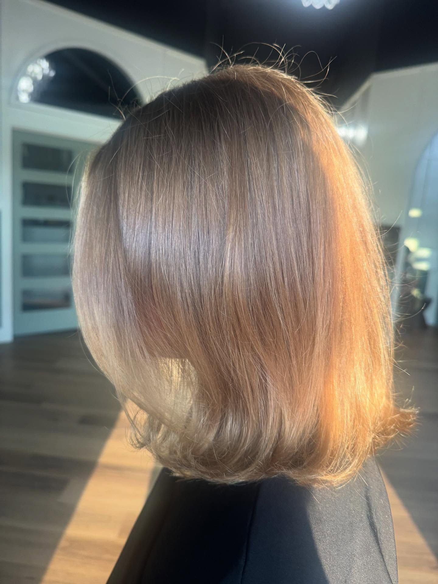 Shoulder-length, smooth, light-brown hair with a sunlit, ombre effect.