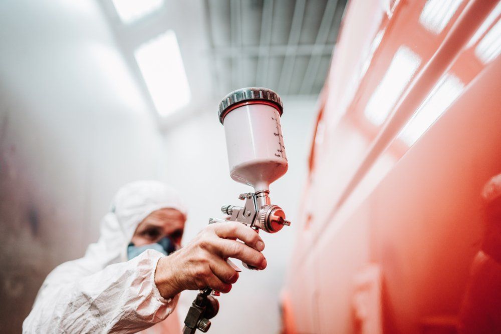 A Man Holding a Spray Gun With Mask on the Face — Dynamic 2-Pack In Rockville, QLD