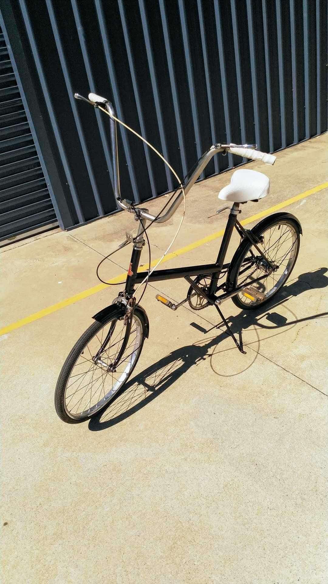 A Black Bicycle With a White Seat is Parked on the Side of the Road — Dynamic 2-Pack In Rockville, QLD