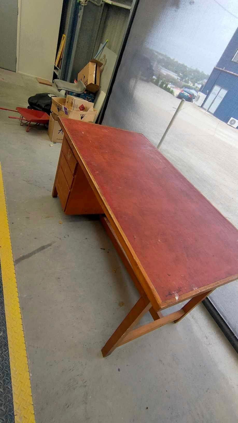 A Red Wooden Desk is Sitting on a Concrete Floor in a Warehouse — Dynamic 2-Pack In Rockville, QLD