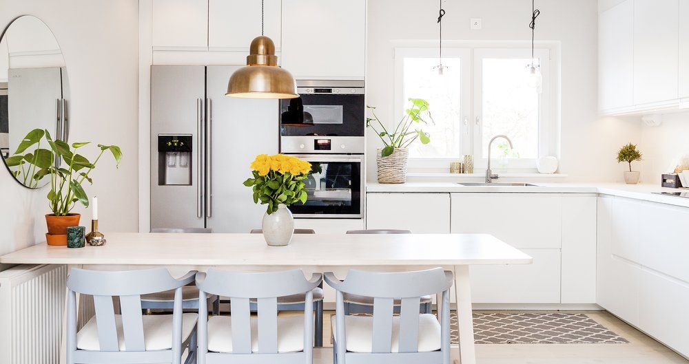 A Kitchen With White Cabinets , a Refrigerator, a Sink, a Table and Chairs — Dynamic 2-Pack In Rockville, QLD