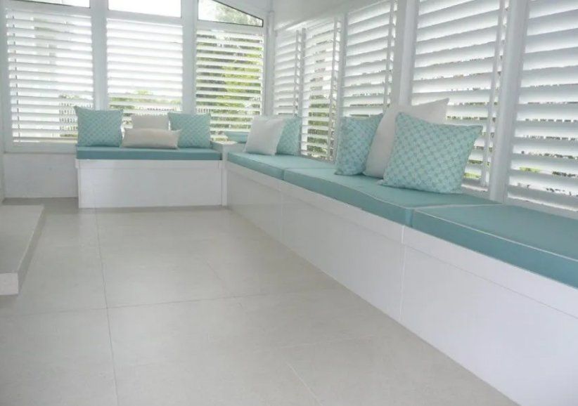 A Window Seat With Blue Cushions and White Shutters — Dynamic 2-Pack In Rockville, QLD