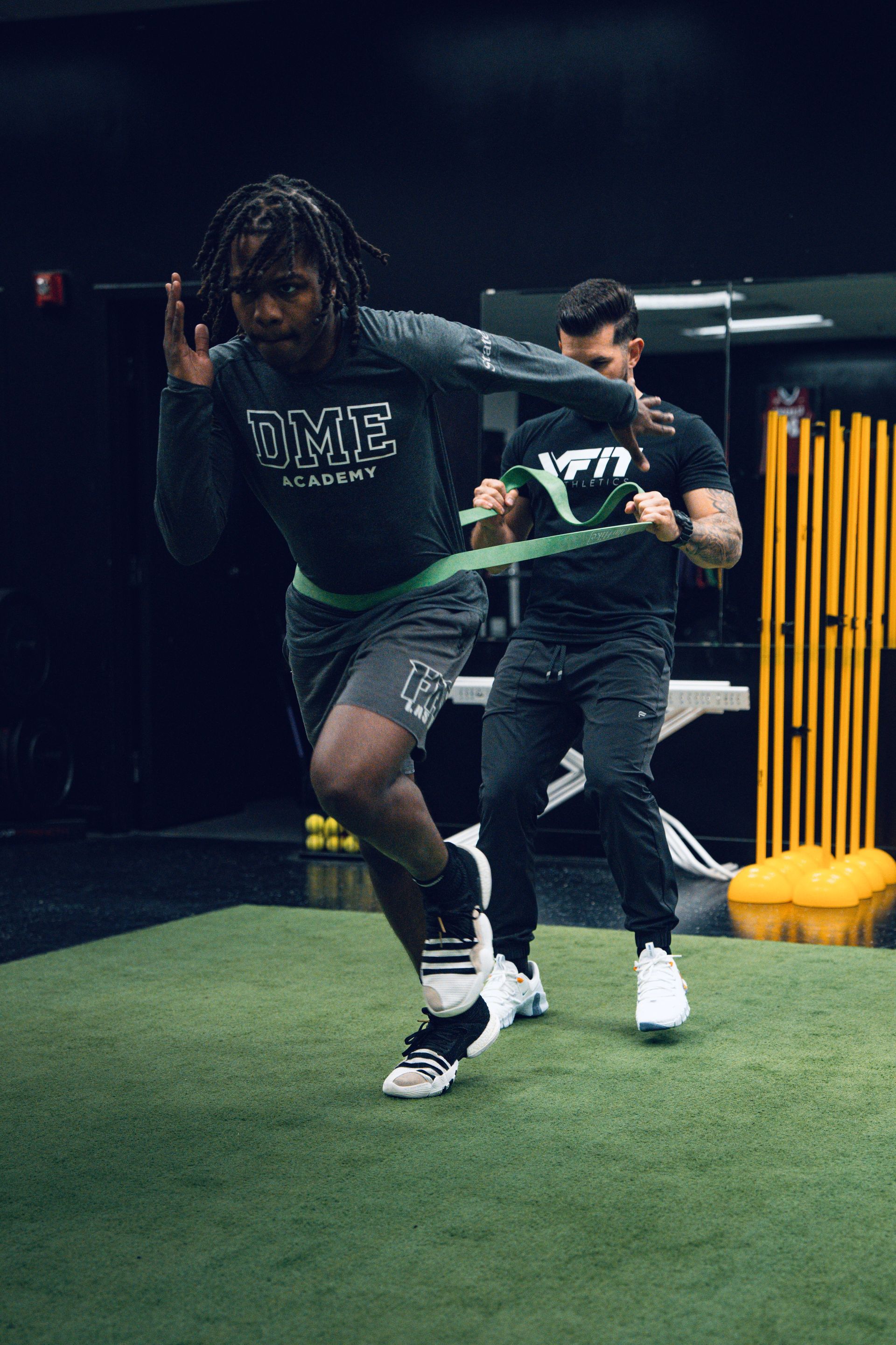 A man is running with a resistance band around his waist.