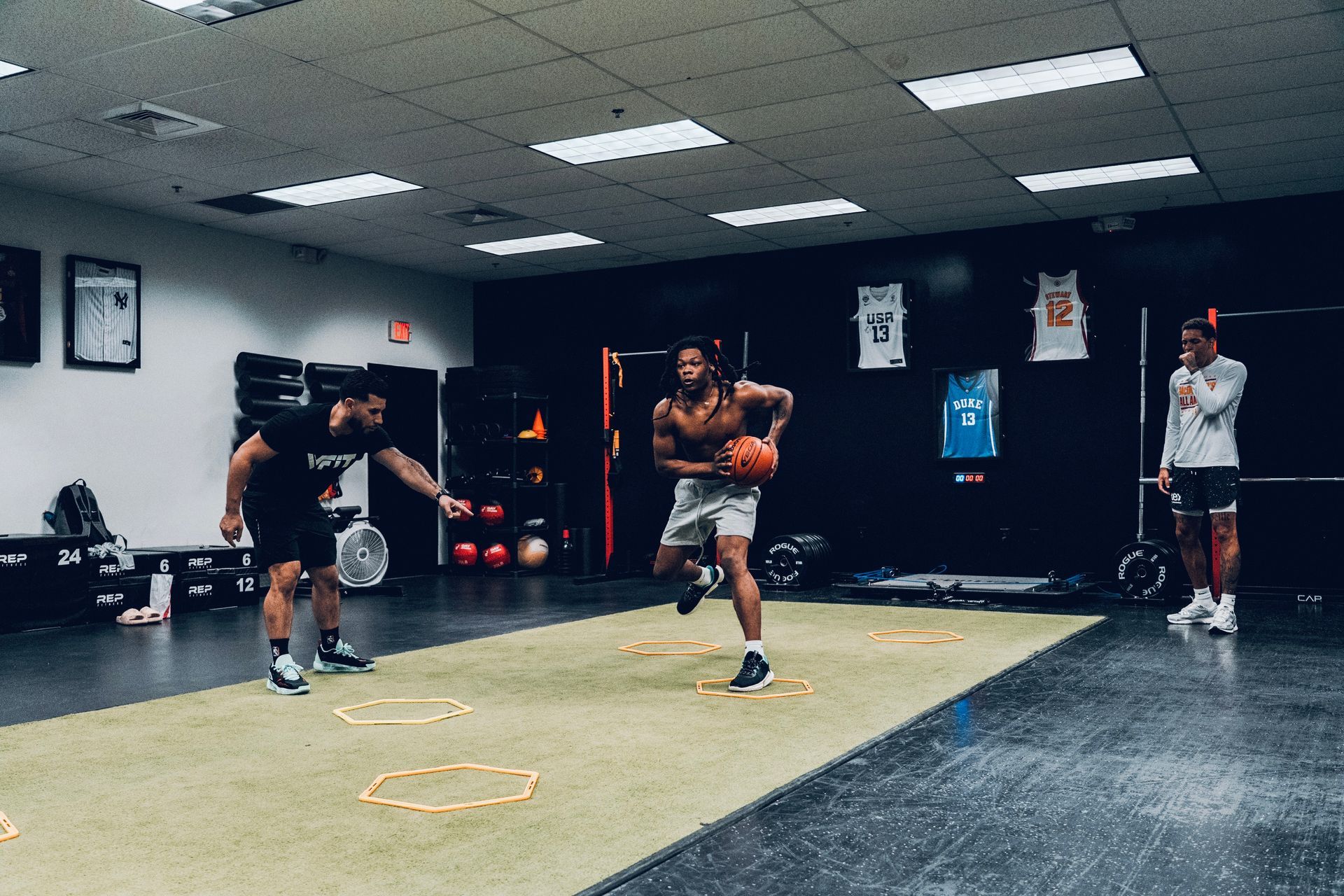 A group of men are playing basketball in a gym.