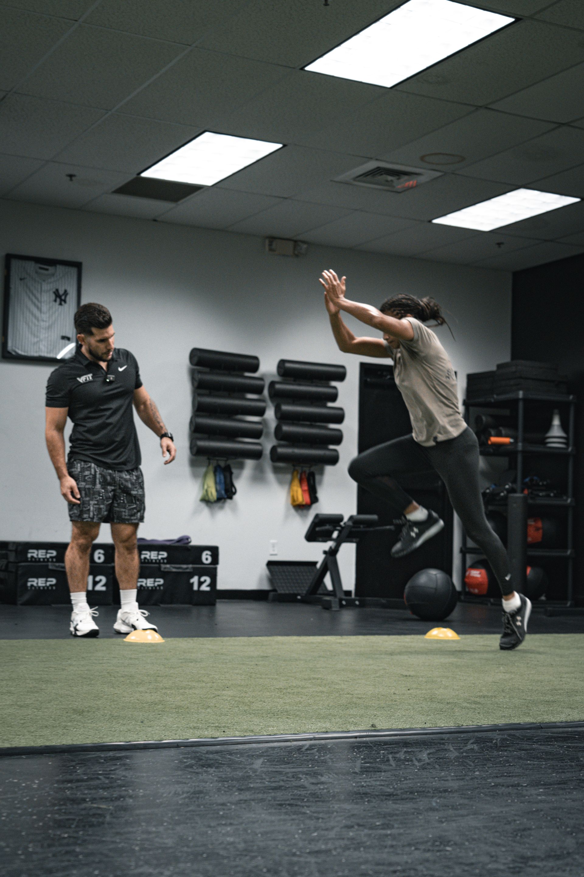 A man and a woman are doing exercises in a gym.