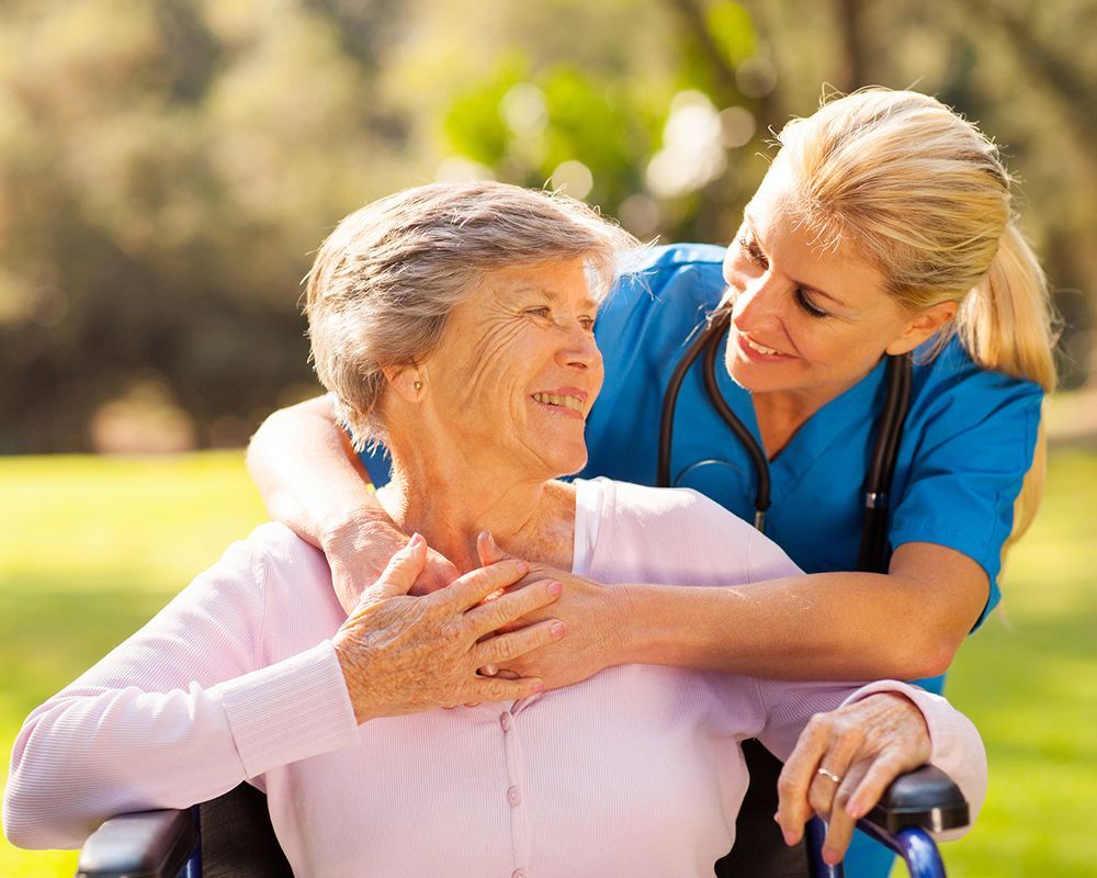 caring nurse with senior lady