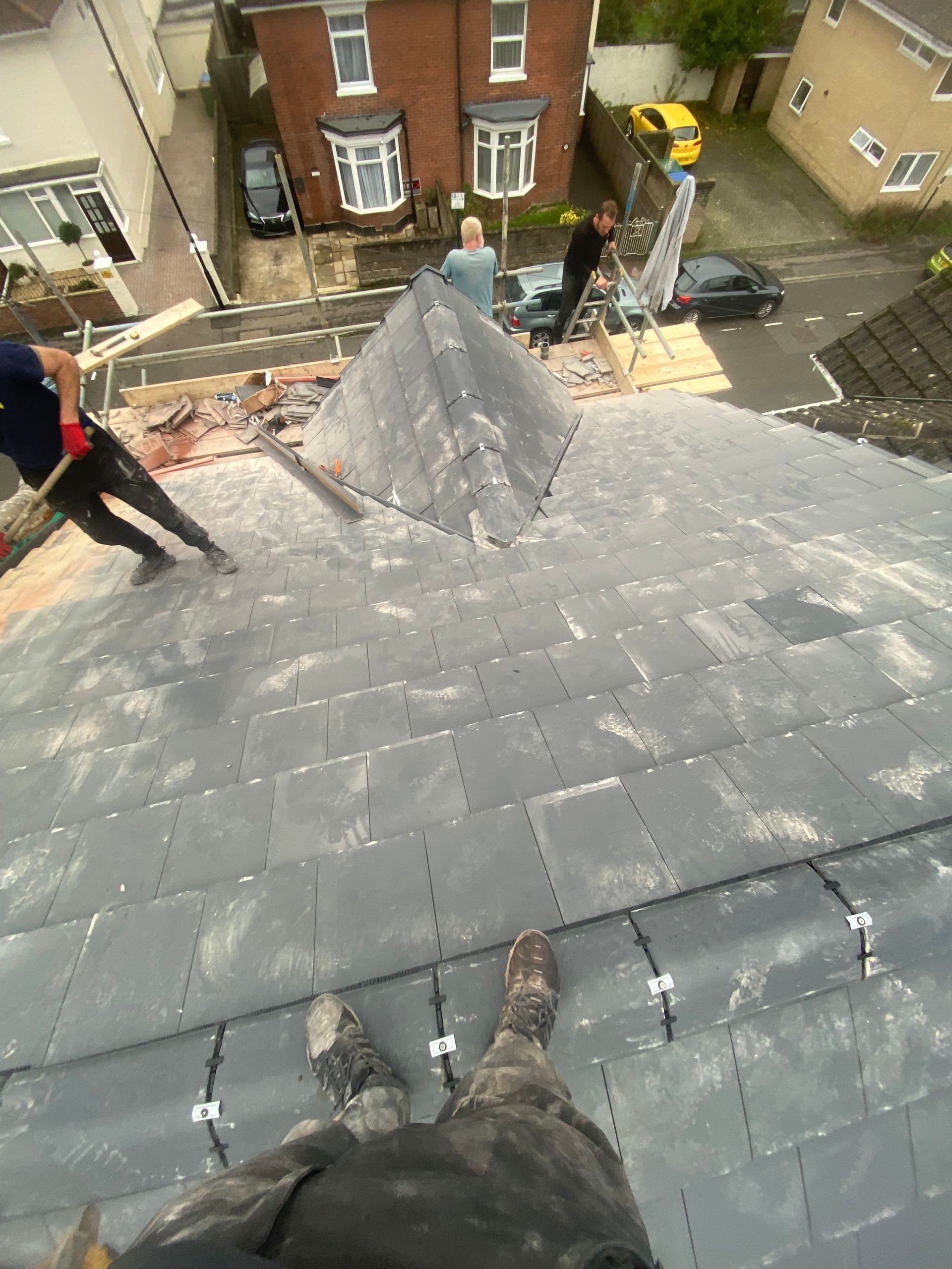 A group of people are working on a roof.
