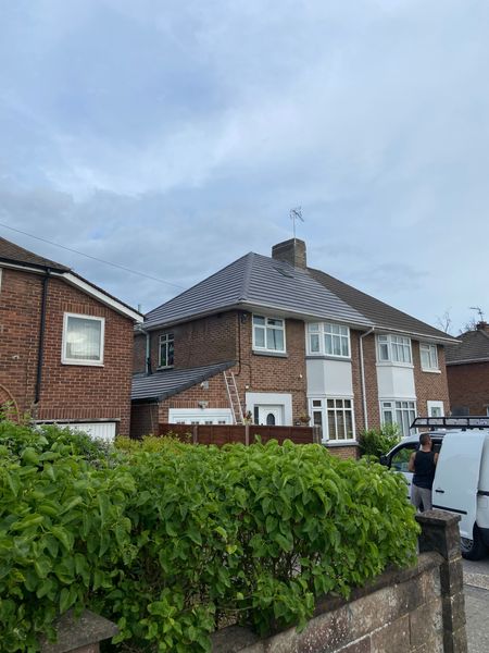 A brick house with a white van parked in front of it.