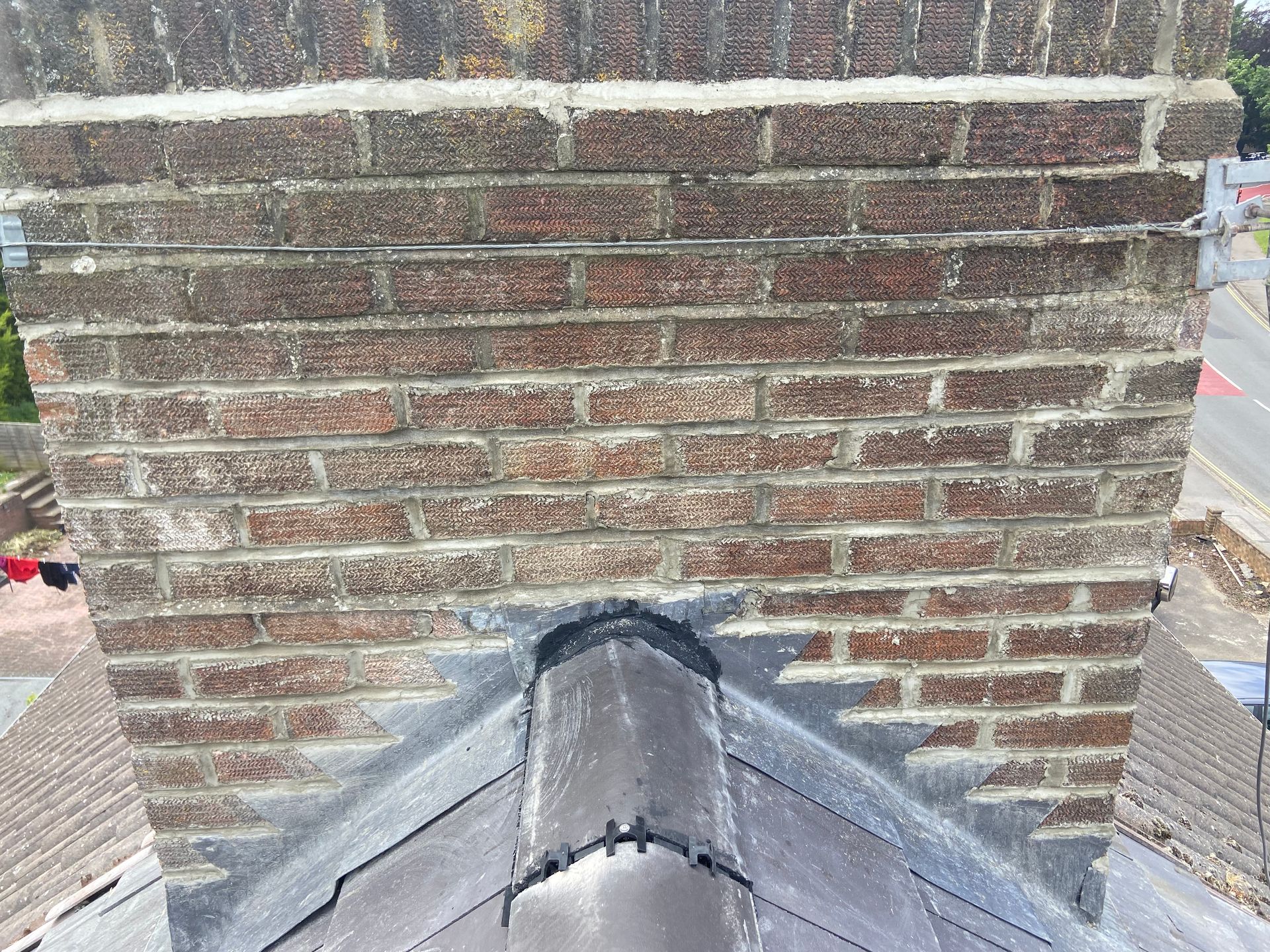 A close up of a brick chimney on top of a roof.